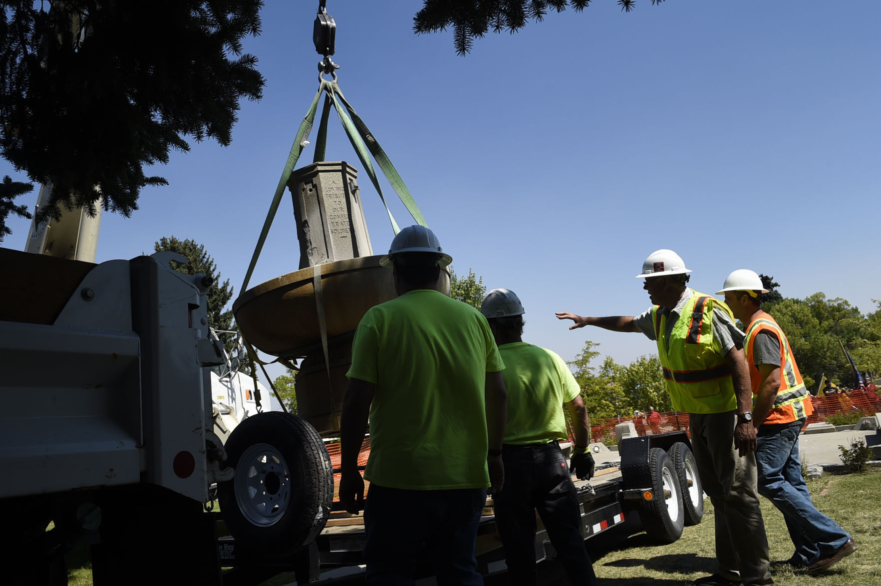 City of Helena employees load the Confederate Fountain on to a trailer after it was removed from Hill Park.
